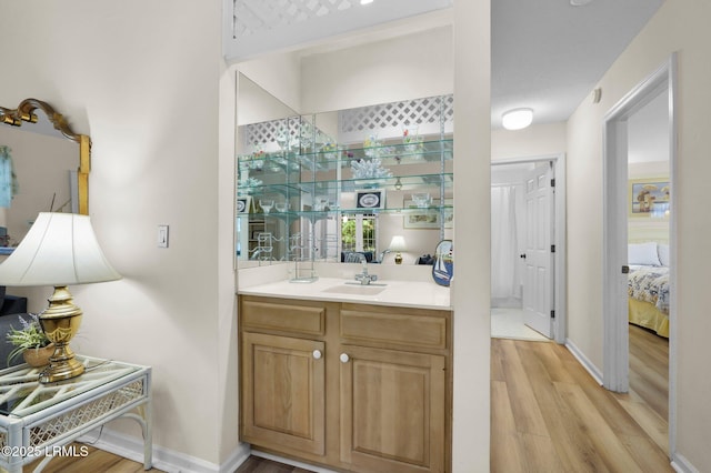 70 Shipyard Dr Unit 166, Hilton Head Island, SC 29928 - ensuite bathroom with wood finished floors, vanity, and baseboards