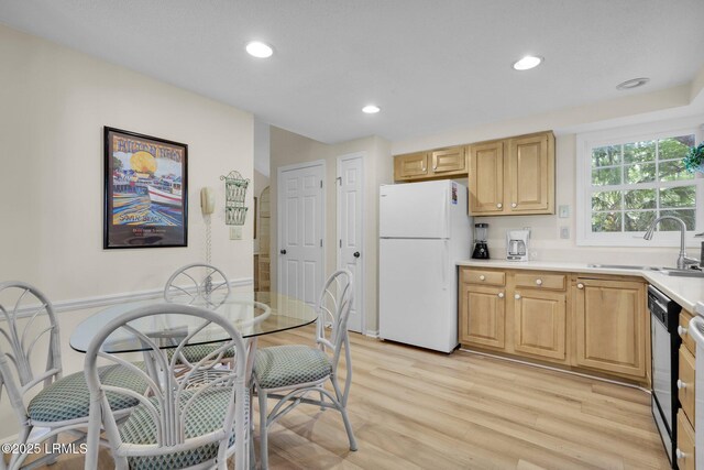 70 Shipyard Dr Unit 166, Hilton Head Island, SC 29928 - kitchen featuring freestanding refrigerator, a sink, light wood-style floors, light countertops, and dishwasher