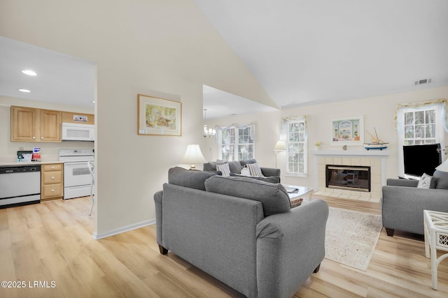 70 Shipyard Dr Unit 166, Hilton Head Island, SC 29928 - living area featuring light wood-style flooring, plenty of natural light, a tile fireplace, recessed lighting, and baseboards