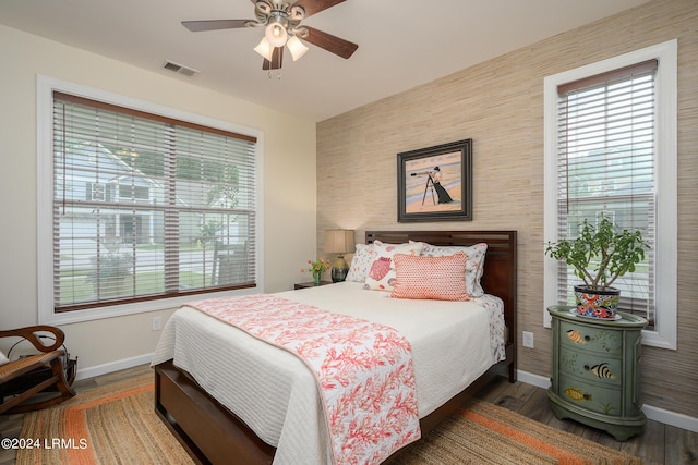 bedroom with dark hardwood / wood-style floors and ceiling fan