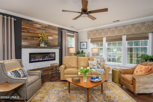 living room with hardwood / wood-style flooring, ornamental molding, ceiling fan, and wooden walls