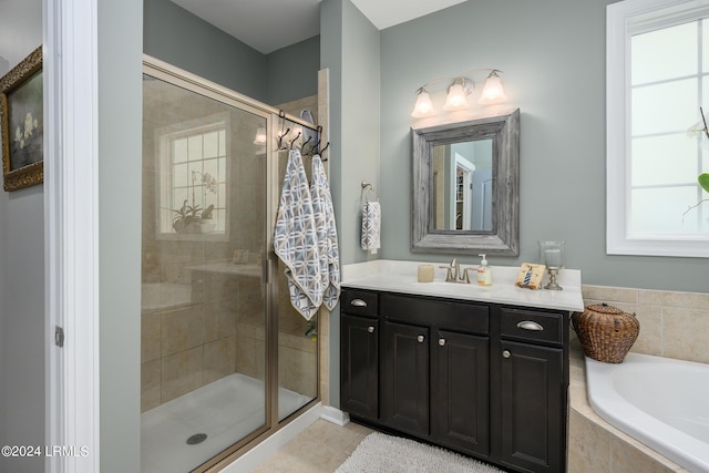 bathroom featuring shower with separate bathtub and vanity