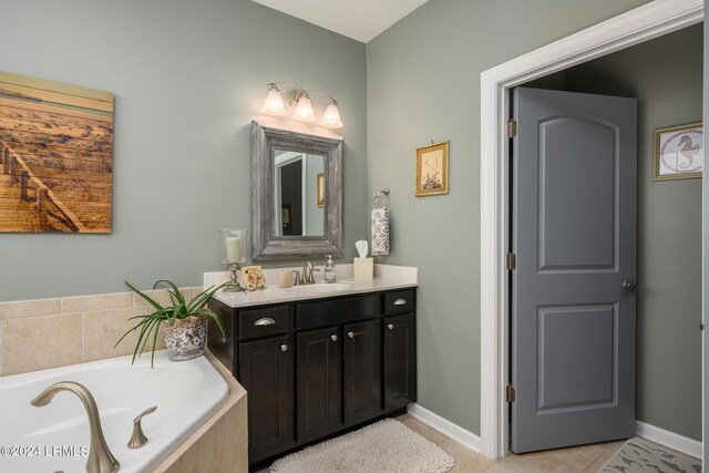 bathroom with vanity, a relaxing tiled tub, and tile patterned floors