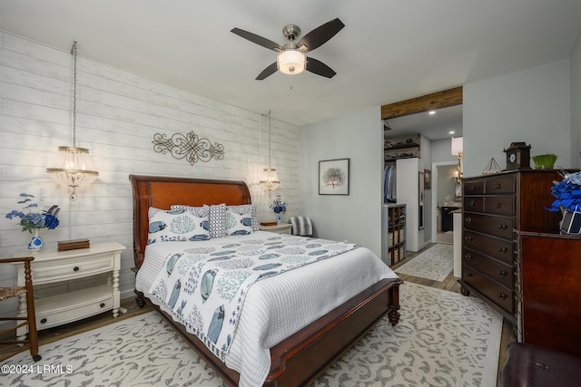 bedroom with ceiling fan, a closet, and light wood-type flooring