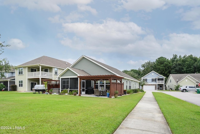 rear view of property with a yard, a gazebo, and a garage