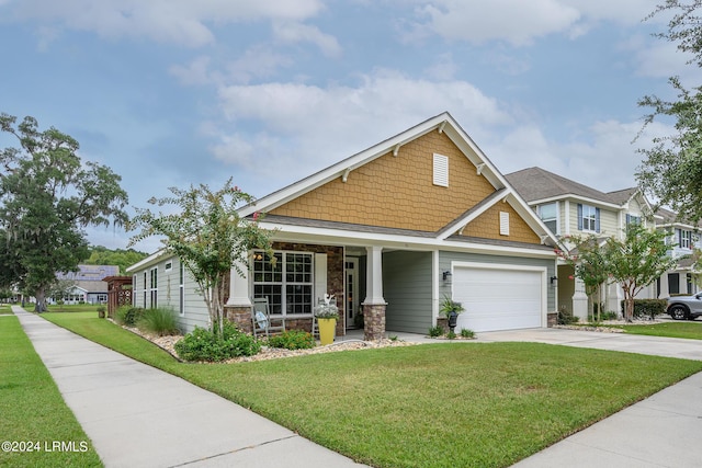 craftsman-style home with a garage, a front lawn, and a porch