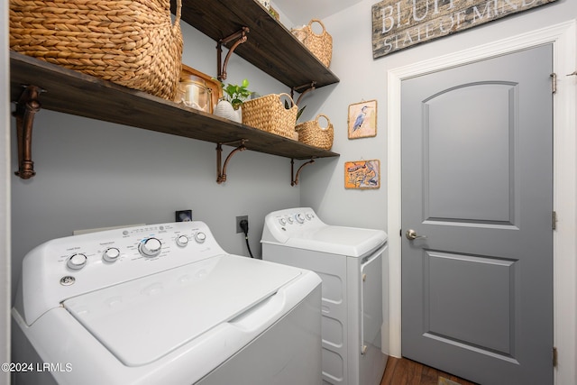 clothes washing area featuring independent washer and dryer and dark hardwood / wood-style flooring