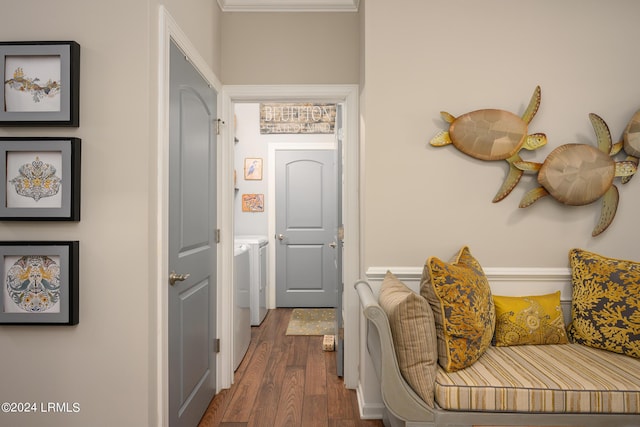 hallway with dark wood-type flooring and washing machine and dryer