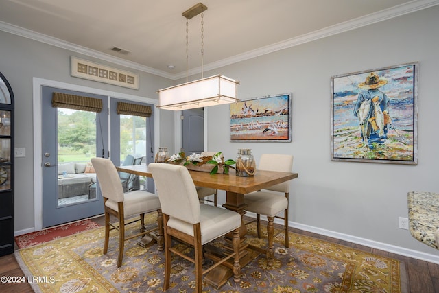 dining space featuring crown molding and dark hardwood / wood-style floors