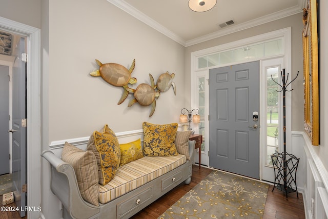 foyer entrance with ornamental molding and dark hardwood / wood-style floors