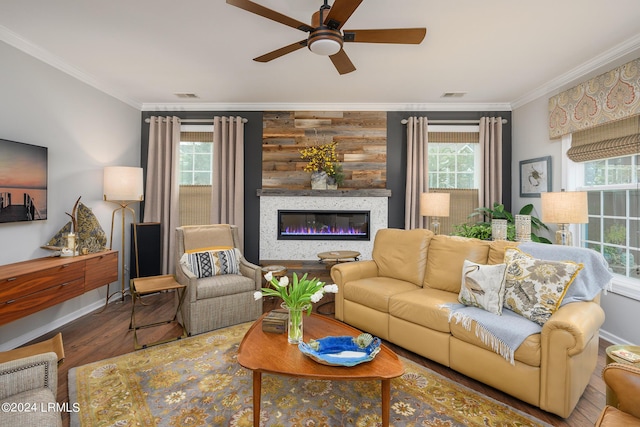 living room with crown molding, ceiling fan, wooden walls, and hardwood / wood-style flooring