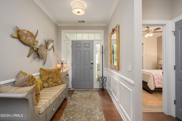 foyer with ornamental molding and dark hardwood / wood-style flooring