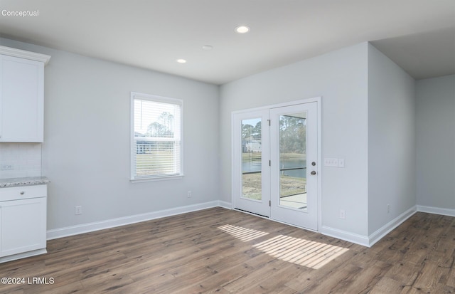 unfurnished dining area featuring dark wood-type flooring