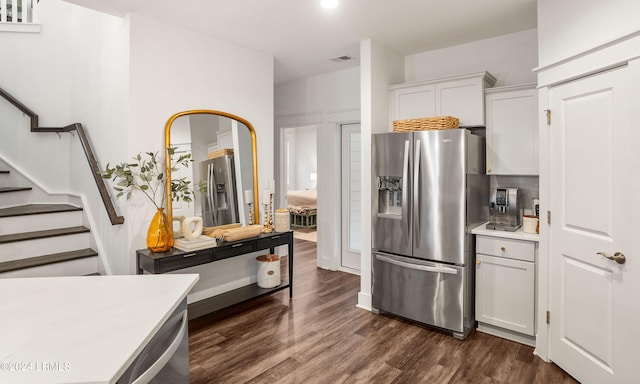 kitchen with stainless steel appliances, dark hardwood / wood-style floors, and white cabinets