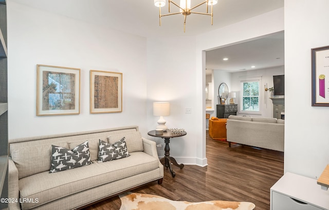 living room featuring dark hardwood / wood-style floors and a chandelier