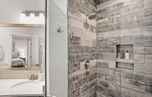 bathroom featuring vanity and tiled shower