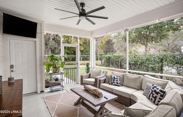 sunroom featuring ceiling fan