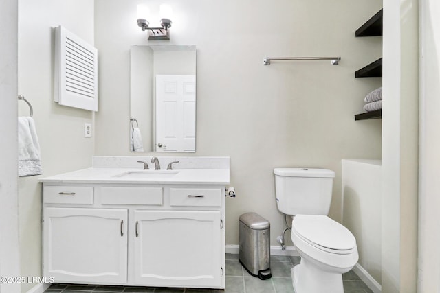 bathroom with tile patterned flooring, baseboards, vanity, and toilet