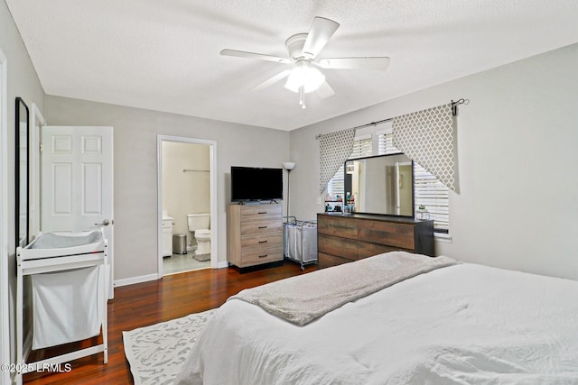 bedroom with ceiling fan, a textured ceiling, connected bathroom, baseboards, and dark wood finished floors