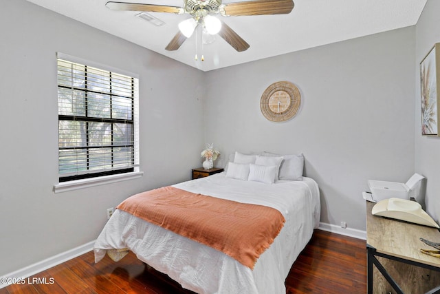 bedroom featuring ceiling fan, baseboards, and wood finished floors