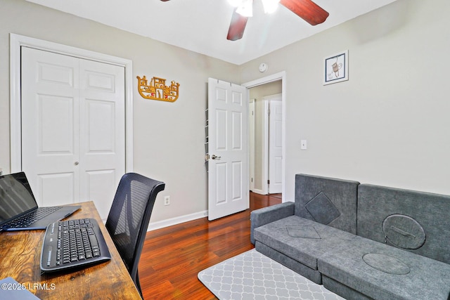 home office with a ceiling fan, baseboards, and wood finished floors