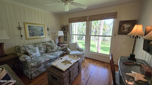 129 Sea Otter Ln, Fripp Island, SC 29920 - living room featuring ornamental molding, hardwood / wood-style flooring, plenty of natural light, a ceiling fan, and wooden walls