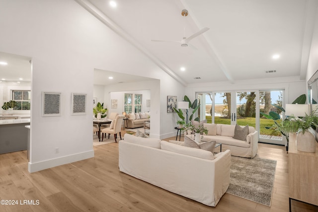 living room featuring beamed ceiling, high vaulted ceiling, and light hardwood / wood-style flooring