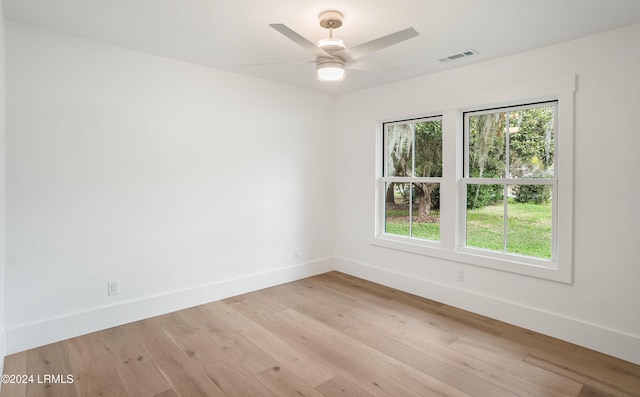 empty room with ceiling fan and light hardwood / wood-style flooring