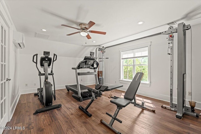 exercise room featuring dark hardwood / wood-style flooring, vaulted ceiling, ceiling fan, and a wall unit AC