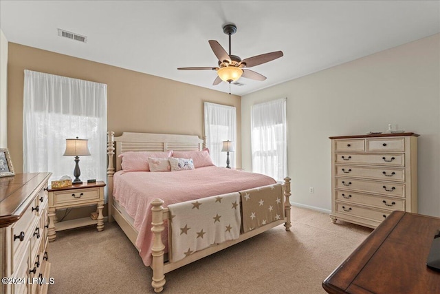 bedroom featuring light carpet and ceiling fan