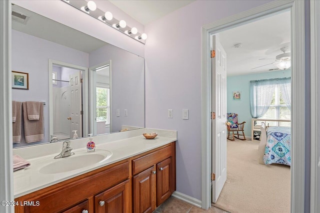 bathroom with vanity, toilet, and ceiling fan