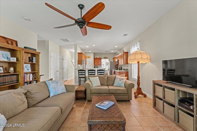 tiled living room with ceiling fan