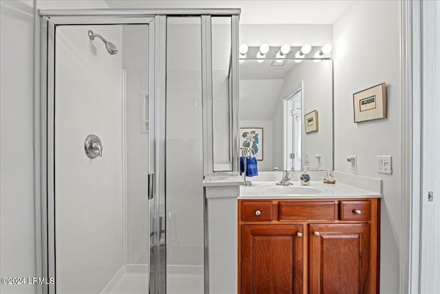 bathroom with a shower with door and vanity