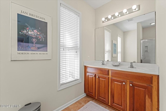 bathroom featuring an enclosed shower, vanity, and tile patterned floors