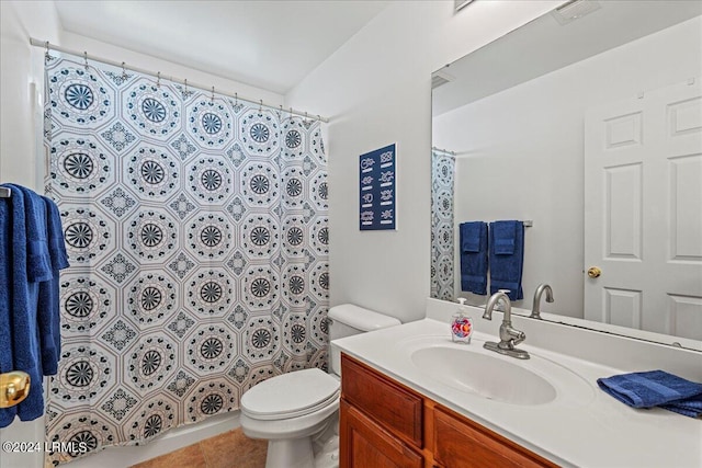 bathroom featuring tile patterned flooring, vanity, and toilet