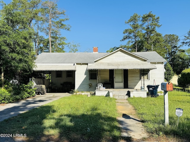 view of front facade featuring a porch and a carport