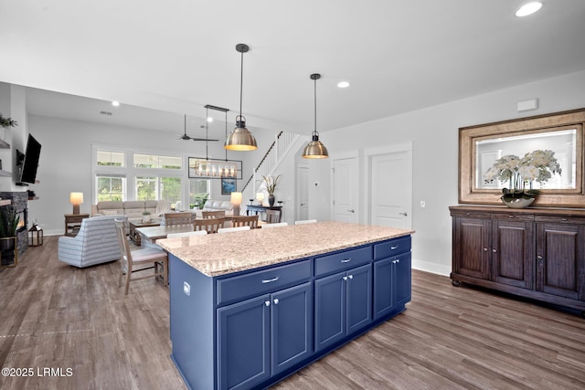 276 Monument St, Ridgeland, SC 29936 - kitchen with blue cabinetry, wood finished floors, recessed lighting, a center island, and baseboards