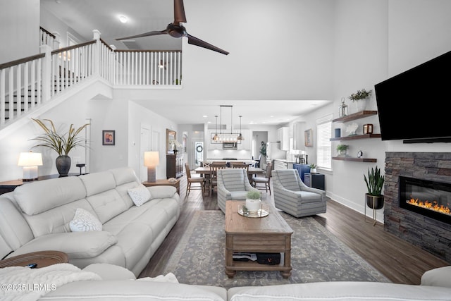 276 Monument St, Ridgeland, SC 29936 - living area featuring wood finished floors, a high ceiling, a fireplace, ceiling fan, and baseboards