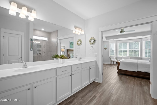 276 Monument St, Ridgeland, SC 29936 - full bath featuring wood finished floors, tiled shower, double vanity, baseboards, and connected bathroom