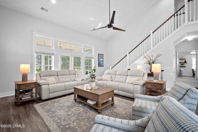276 Monument St, Ridgeland, SC 29936 - living area with a towering ceiling, a ceiling fan, dark wood-style flooring, stairs, and baseboards