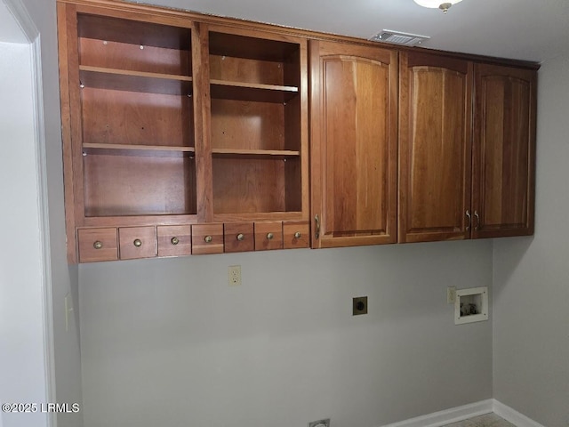 laundry area with electric dryer hookup, hookup for a washing machine, and cabinets