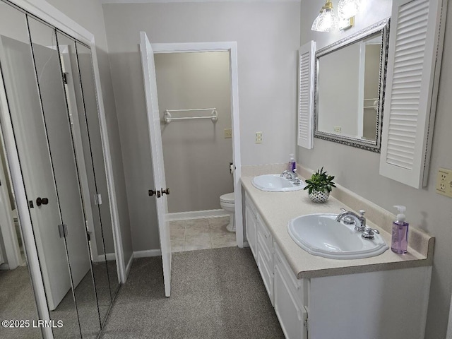 bathroom with vanity, tile patterned flooring, and toilet