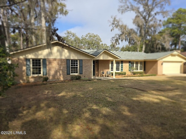 ranch-style house featuring a garage and a front lawn