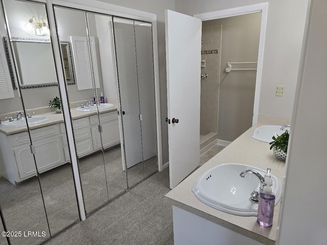 bathroom with vanity and a tile shower