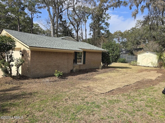 view of home's exterior with a lawn and a storage unit