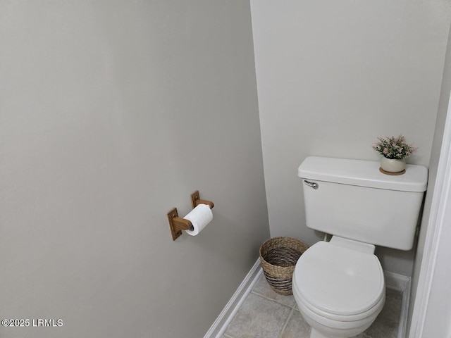 bathroom with toilet and tile patterned flooring