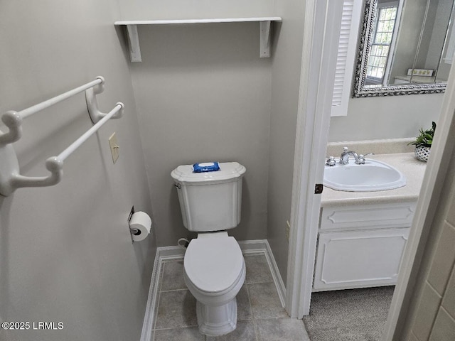 bathroom with tile patterned flooring, vanity, and toilet