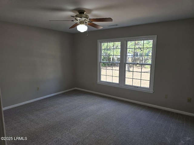 carpeted spare room with ceiling fan