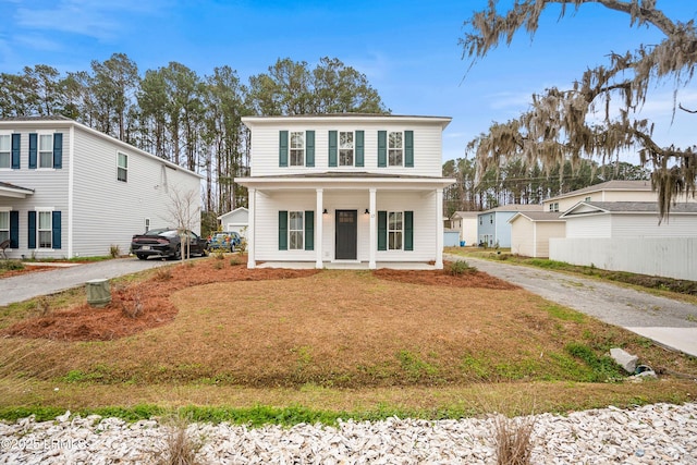 view of front facade featuring driveway and a porch