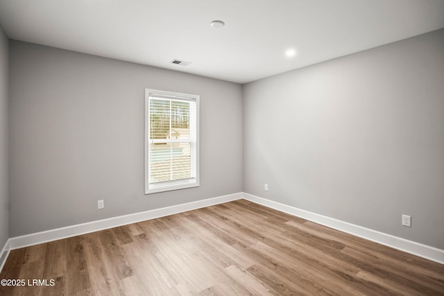 unfurnished room featuring baseboards and wood finished floors